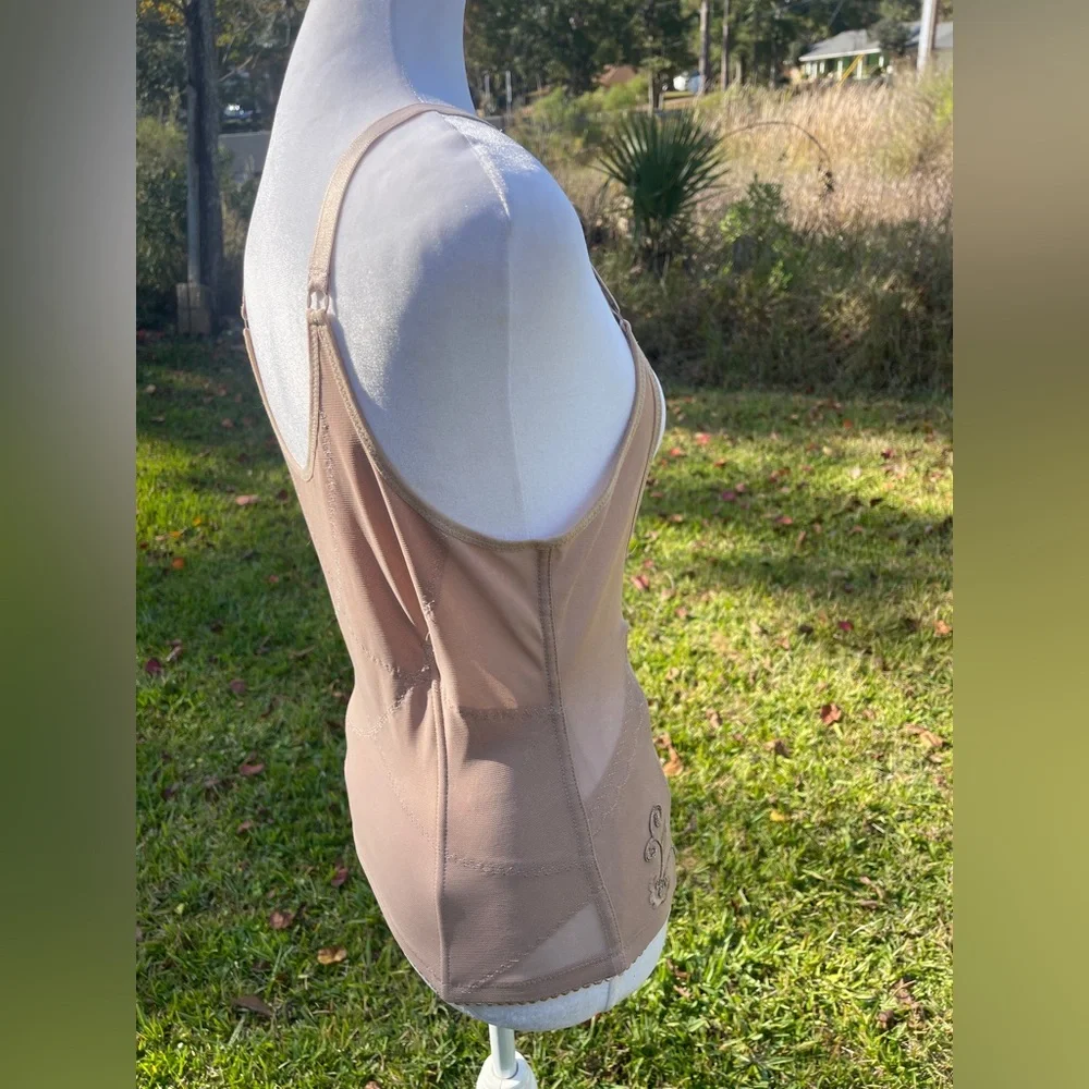 Corset body shaper in beige or nude with adjustable straps & hook/eye closure.